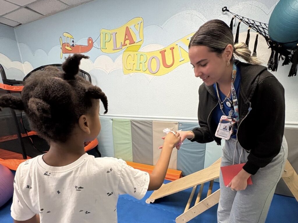ABA therapist building connection through play with child at SuperKids therapy center