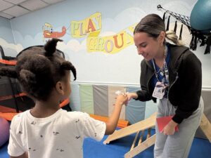 ABA therapist building connection through play with child at SuperKids therapy center