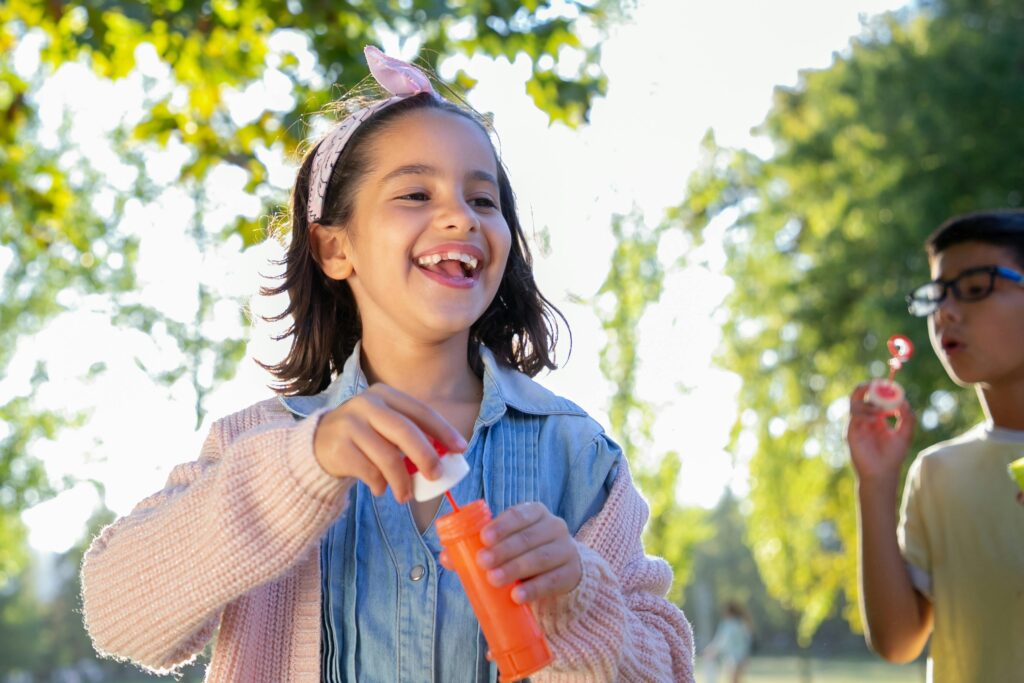 A girl having fun with bubbles in summer